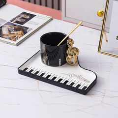 Sip in Musical Style: Golden Accented Piano Cup & Saucer Set